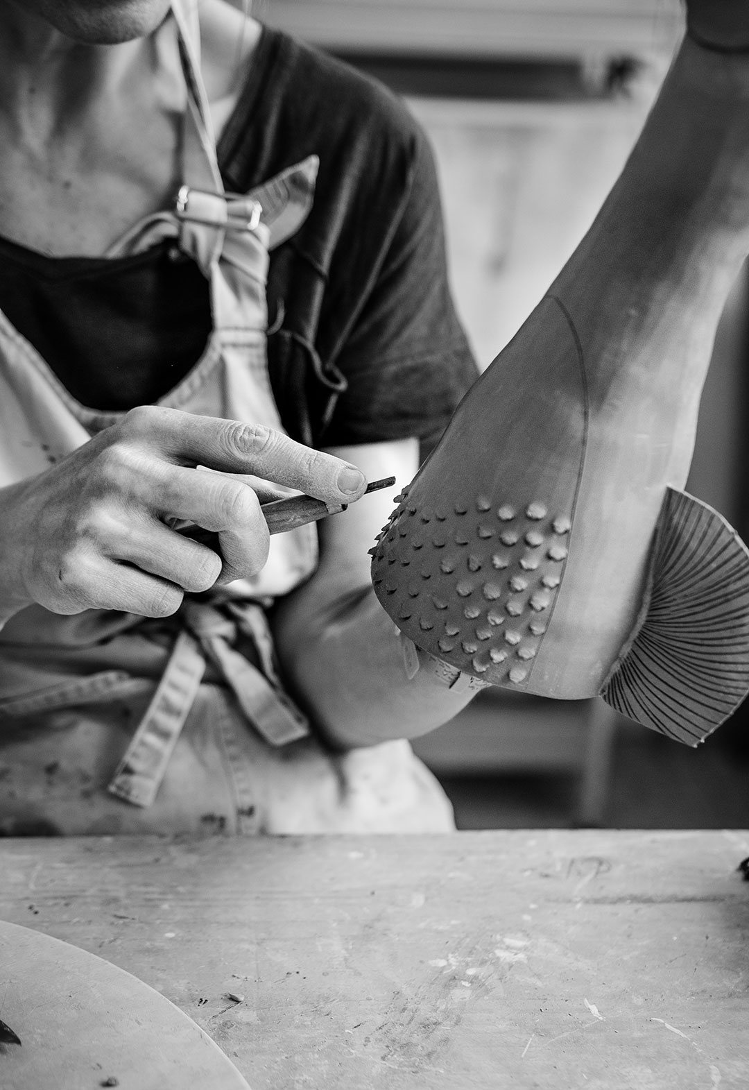 Zoom in on Sandrine Herlin's hands, working in her workshop